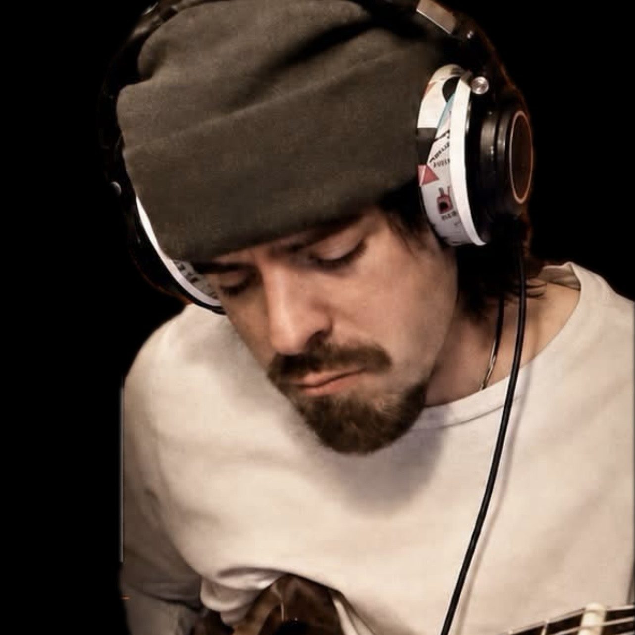 Portrait of Ovation instructor Greg Rausch wearing headphones.