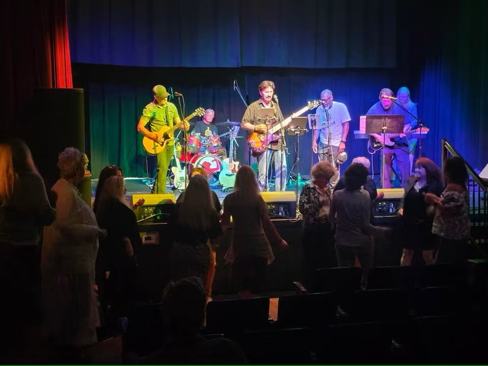 Musicians performing on stage for a crowd at Gallatin's Main Street Festival.